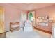 Charming Bedroom with crib, chair, and a built-in bookshelf filled with books at 1226 Dexter St, Denver, CO 80220
