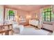 Charming Bedroom with pink walls, a crib, and natural light from the window at 1226 Dexter St, Denver, CO 80220