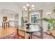 Elegant dining room featuring modern chandelier, large windows, and a stylish round table at 1226 Dexter St, Denver, CO 80220