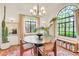 Bright dining area with large windows, unique lighting, and views of the outdoor greenery at 1226 Dexter St, Denver, CO 80220