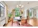 Airy dining room with large windows, modern chandelier, and stylish wood table setting at 1226 Dexter St, Denver, CO 80220