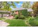 Charming home exterior adorned with lush greenery and a well-manicured lawn and stone pathway at 1226 Dexter St, Denver, CO 80220