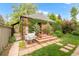 Exterior view of brick building covered in greenery, with a grill and access steps at 1226 Dexter St, Denver, CO 80220