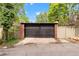 Well-maintained two-car garage featuring a neutral-colored brick exterior providing secure parking and potential storage at 1226 Dexter St, Denver, CO 80220