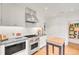 Bright kitchen with stainless steel appliances, gas range, and custom butcher block island at 1226 Dexter St, Denver, CO 80220