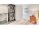 Efficient laundry area featuring a stacked washer and dryer, sleek countertops, and a bright window for added convenience at 1226 Dexter St, Denver, CO 80220