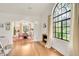 Elegant living room with hardwood floors, large arched window, and decorative fireplace at 1226 Dexter St, Denver, CO 80220