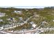 Breathtaking aerial view of a home surrounded by trees and mountains, showcasing natural beauty at 10747 Timothys Dr, Conifer, CO 80433