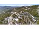 Scenic aerial view of homes nestled among the trees in the mountains at 10747 Timothys Dr, Conifer, CO 80433