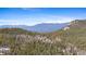 Mountain home nestled in a dense forest with a scenic view of snow capped mountain peaks at 10747 Timothys Dr, Conifer, CO 80433