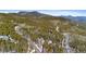 Stunning aerial view of a home nestled among trees in a mountainous landscape at 10747 Timothys Dr, Conifer, CO 80433
