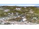 Expansive aerial view of a home surrounded by trees, illustrating the property's peaceful setting at 10747 Timothys Dr, Conifer, CO 80433