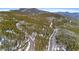 Aerial view highlighting property nestled amid the trees, accessible by winding roads at 10747 Timothys Dr, Conifer, CO 80433