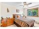Bright bedroom with ceiling fan, wood furniture and decorative accents at 10747 Timothys Dr, Conifer, CO 80433
