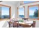 Dining area featuring a table with chairs, mountain views, and wood finishes at 10747 Timothys Dr, Conifer, CO 80433