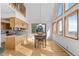 Dining area featuring a table with seating, large windows, and light wood finishes at 10747 Timothys Dr, Conifer, CO 80433