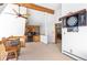 Open floorplan game room with barrel table, dart board and wood beam ceiling at 10747 Timothys Dr, Conifer, CO 80433