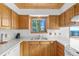 Charming kitchen with wooden cabinets, bright countertops, and natural light at 10747 Timothys Dr, Conifer, CO 80433