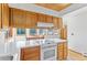 Bright kitchen with wood accents, white countertops, and open dining area at 10747 Timothys Dr, Conifer, CO 80433