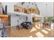 Inviting living room with hardwood floors, stone fireplace, a loft and an adjacent kitchen with breakfast nook at 10747 Timothys Dr, Conifer, CO 80433