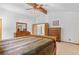 Bright main bedroom featuring wood beam ceiling and matching wood furniture at 10747 Timothys Dr, Conifer, CO 80433