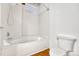 Clean bathroom featuring a white bathtub with shower and updated white toilet at 1745 Wazee St # 2B, Denver, CO 80202