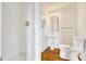 Well-lit bathroom with walk-in shower and sleek pedestal sink with tiled walls at 1745 Wazee St # 2B, Denver, CO 80202
