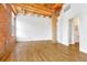 Bedroom featuring hardwood floors, exposed brick, and a modern bathroom at 1745 Wazee St # 2B, Denver, CO 80202