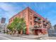 Brick building featuring an industrial style fire escape and mature trees that accent the architecture at 1745 Wazee St # 2B, Denver, CO 80202