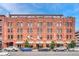 Classic brick building with awnings and street parking, offering a vibrant urban living experience at 1745 Wazee St # 2B, Denver, CO 80202