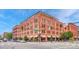Corner view of a red brick building featuring street level retail and residential upper floors with parking at 1745 Wazee St # 2B, Denver, CO 80202