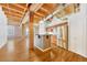 Kitchen island and stainless steel appliances, with exposed beam ceiling and hardwood floors at 1745 Wazee St # 2B, Denver, CO 80202