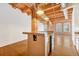 Kitchen with modern island, hardwood floors, and exposed wood beam ceiling at 1745 Wazee St # 2B, Denver, CO 80202