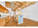 Spacious kitchen featuring wood beams, stainless steel appliances, and an open concept design at 1745 Wazee St # 2B, Denver, CO 80202