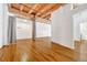 Expansive living area featuring exposed wood beams, hardwood floors, and adaptable space at 1745 Wazee St # 2B, Denver, CO 80202