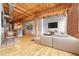 Spacious living room with exposed wood beams, hardwood floors, and brick accent wall at 1745 Wazee St # 2B, Denver, CO 80202
