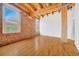 Open room with exposed brick and wooden beams, offering an industrial and warm feel at 1745 Wazee St # 2B, Denver, CO 80202