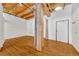 Spacious open living area with hardwood floors and unique wood beam architectural design at 1745 Wazee St # 2B, Denver, CO 80202