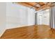 Bright and spacious living area with hardwood floors and prominent wood beam construction at 1745 Wazee St # 2B, Denver, CO 80202
