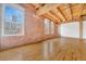 Bright living room with exposed brick wall, hardwood floors, and large windows at 1745 Wazee St # 2B, Denver, CO 80202