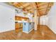 Open concept living space with exposed wood beams, hardwood floors, and ample natural light at 1745 Wazee St # 2B, Denver, CO 80202