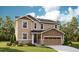 Charming two-story home features a stone-accented facade, attached two-car garage, and well-manicured lawn at 7127 E 126Th Pl, Thornton, CO 80602