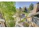 Aerial view of property with mature trees, cars parked, and tennis courts at 5950 Gunbarrel Ave # F, Boulder, CO 80301