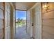 Exterior doorway with light, view of manicured green space with mature trees, pool and sky at 5950 Gunbarrel Ave # F, Boulder, CO 80301