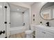 Updated bathroom with white herringbone tile shower and black hardware, including a sleek round mirror at 5950 Gunbarrel Ave # F, Boulder, CO 80301