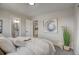 Bright bedroom features an ensuite bath, kitchen views, and art accents at 5950 Gunbarrel Ave # F, Boulder, CO 80301