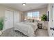 Bright bedroom with large windows, double door closet, cozy rug, and green houseplant accents at 5950 Gunbarrel Ave # F, Boulder, CO 80301