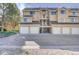 Exterior view of the garages of the townhome with a nicely paved parking area in front at 5950 Gunbarrel Ave # F, Boulder, CO 80301