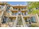 Exterior view of the townhome with balconies and staircase access, in a well-maintained residential building at 5950 Gunbarrel Ave # F, Boulder, CO 80301