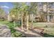 Community exercise area with wood framed equipment and mature trees, alongside a sidewalk and apartment complex at 5950 Gunbarrel Ave # F, Boulder, CO 80301